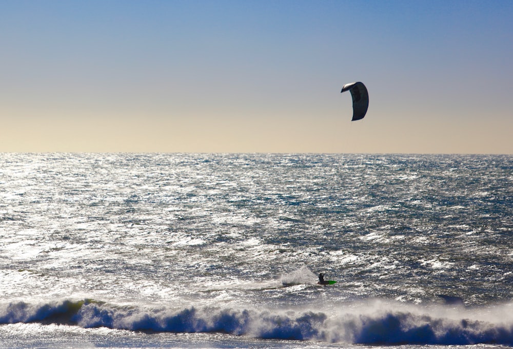 a person para sailing in the ocean on a sunny day