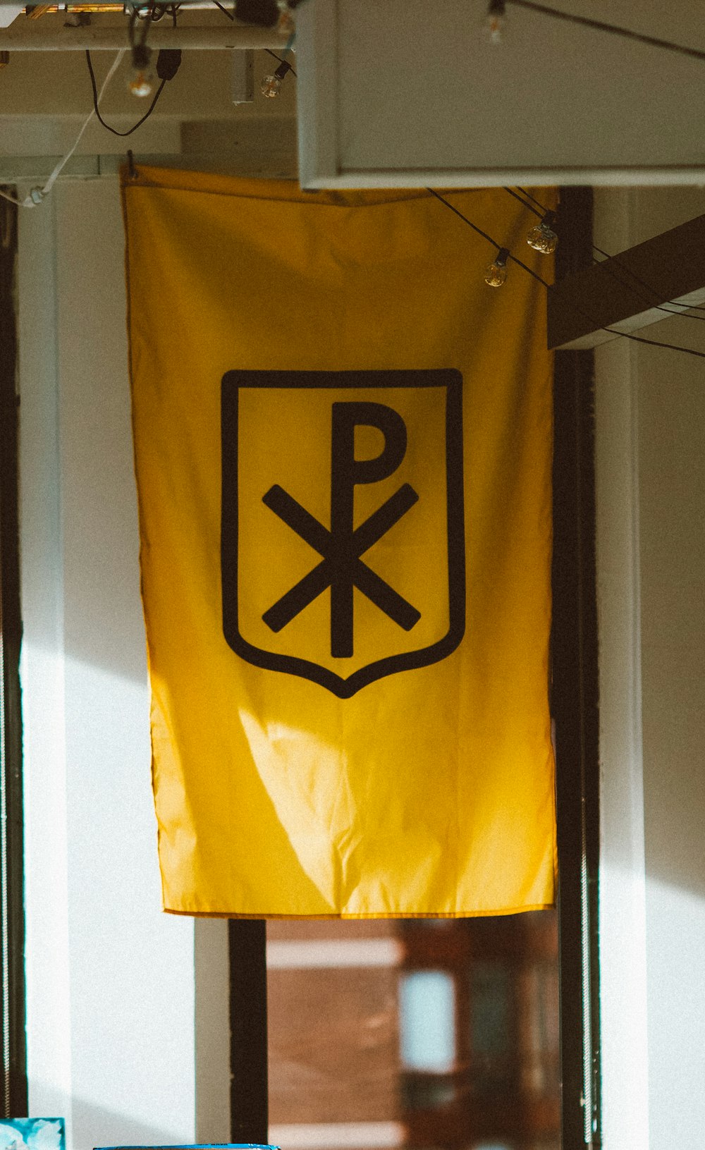 a yellow flag hanging from the ceiling of a room