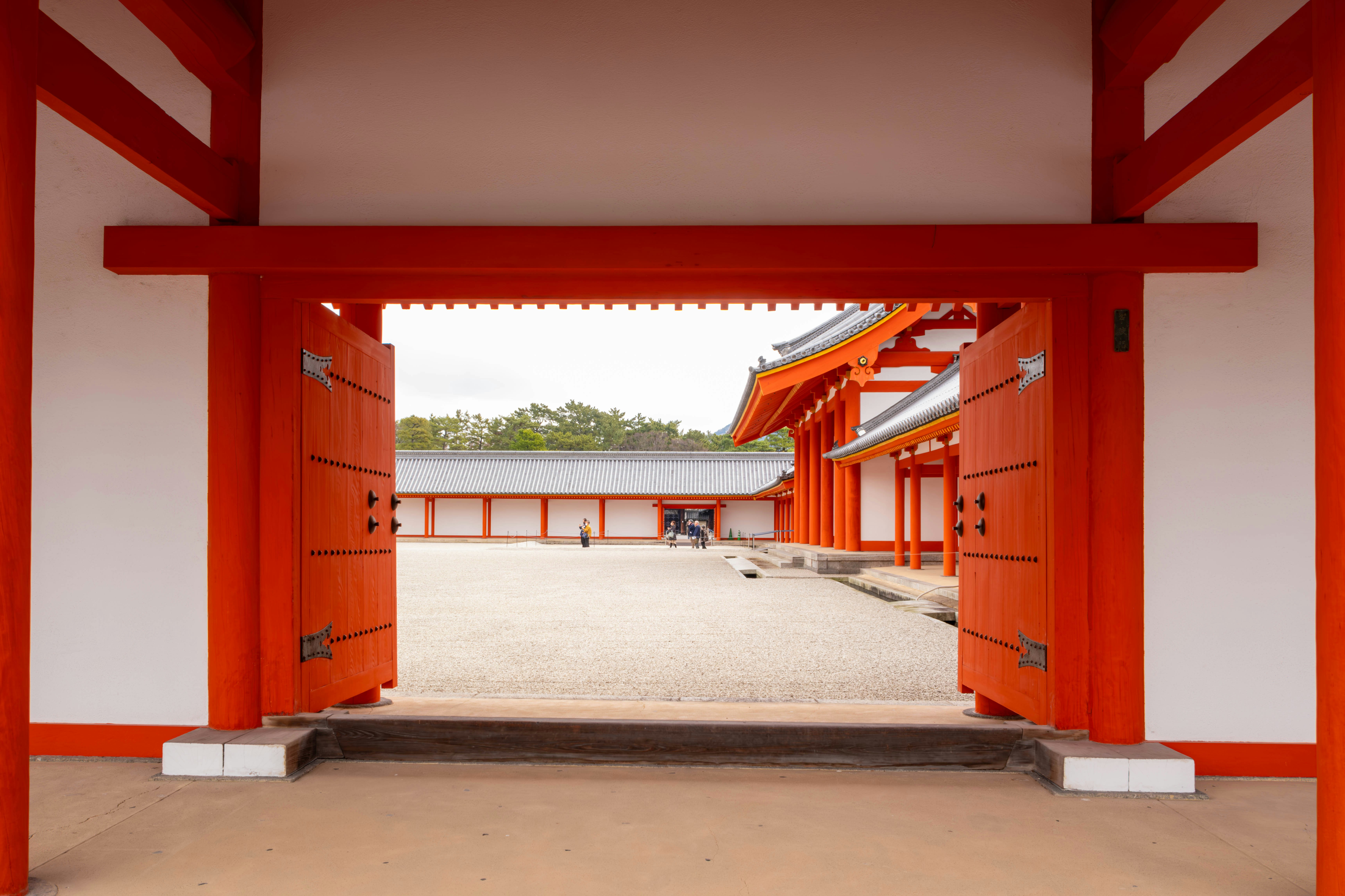 a red and white building with red doors