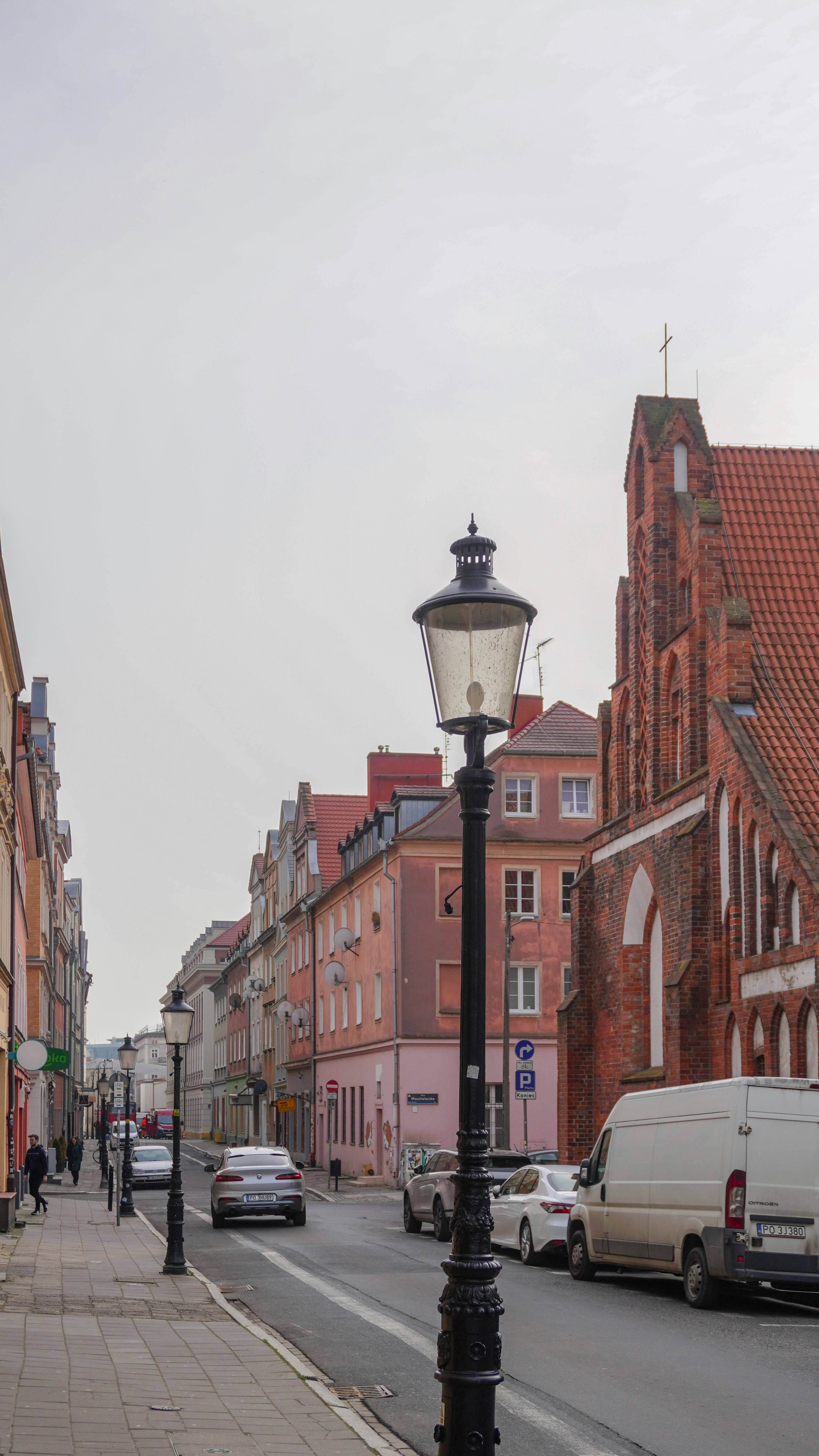 a street light sitting on the side of a road