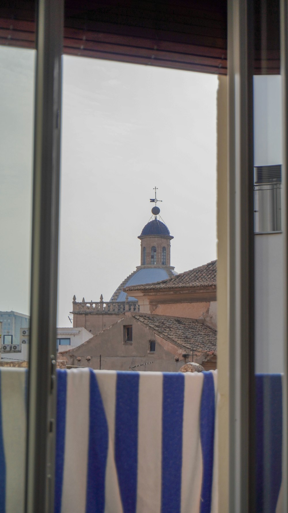 a view out of a window of a building with a clock tower