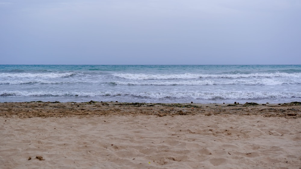 a view of the ocean from a sandy beach