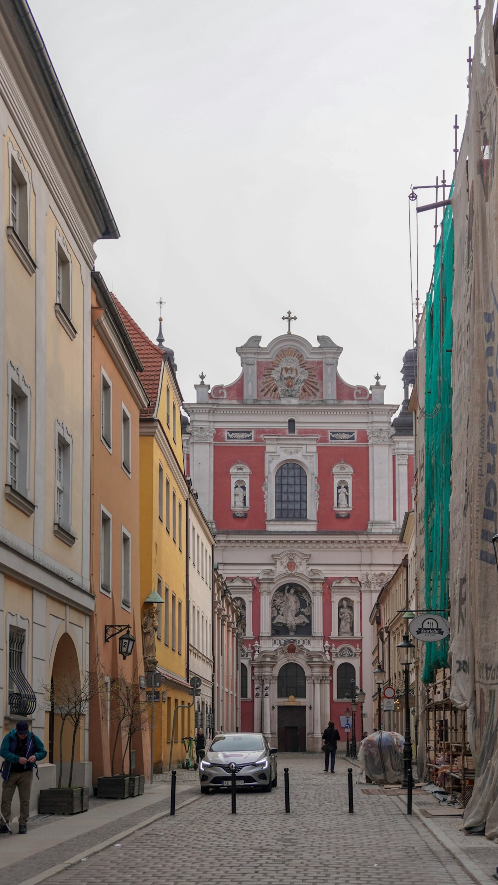 a cobblestone street with a church in the background