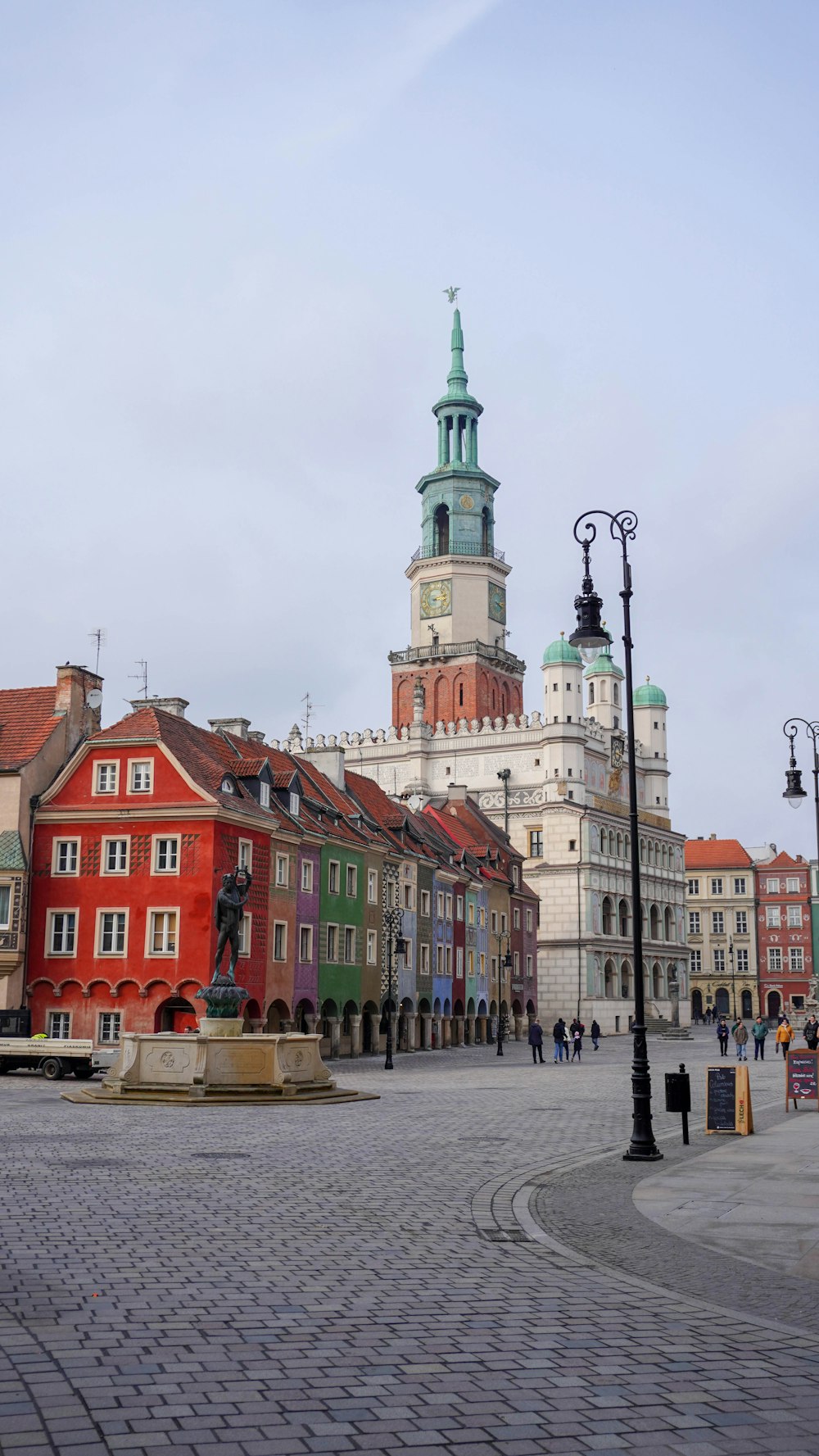 a city square with a clock tower in the background