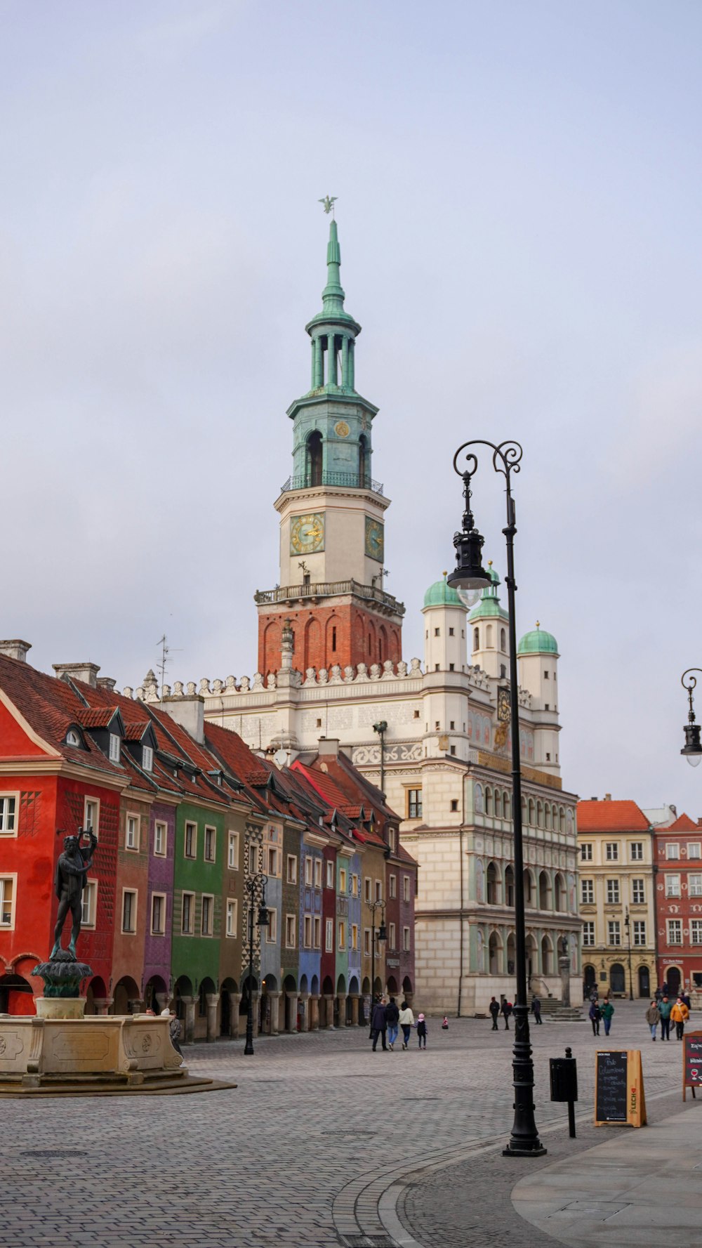 a city square with a clock tower in the background