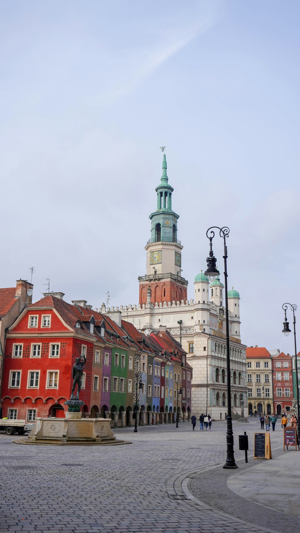 a city square with a clock tower in the background