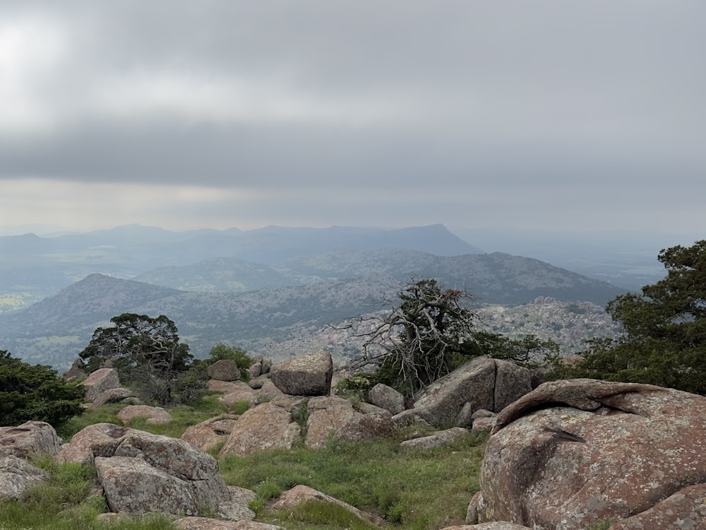 a view of a mountain range from a rocky outcropping