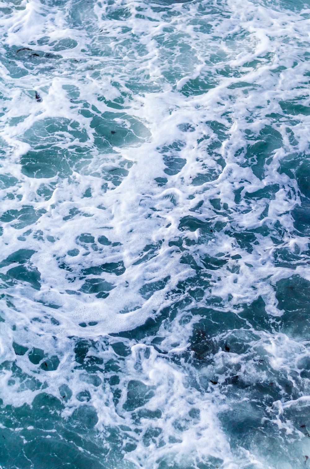 a person riding a surfboard on top of a wave