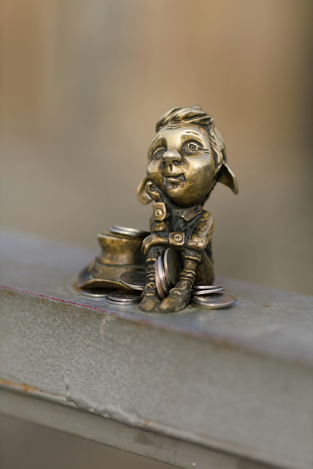 a statue of a little boy sitting on top of a table