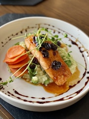 a white plate topped with fish and veggies