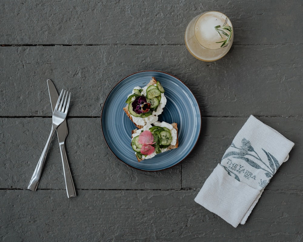 a plate of food on a table next to a glass of water