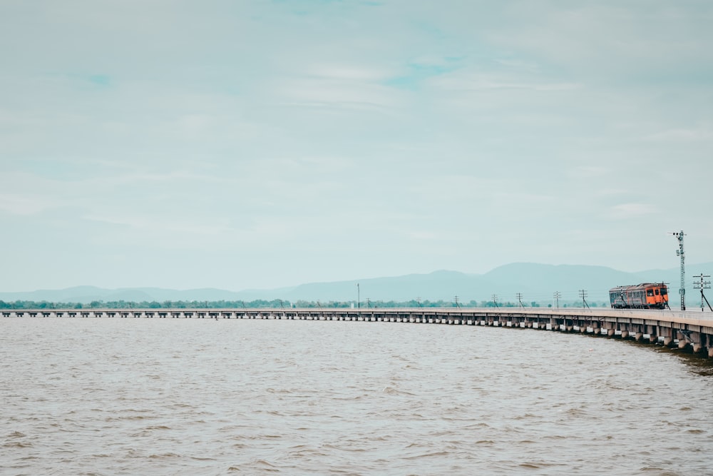 a train traveling over a bridge over a large body of water