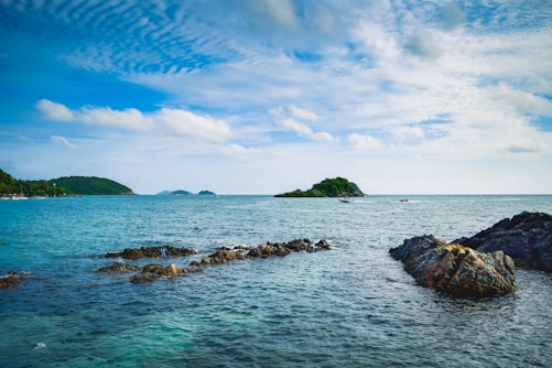 a body of water with rocks in the middle of it