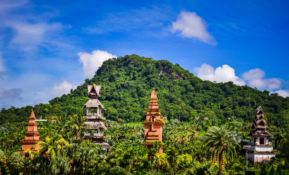 a group of buildings sitting on top of a lush green hillside