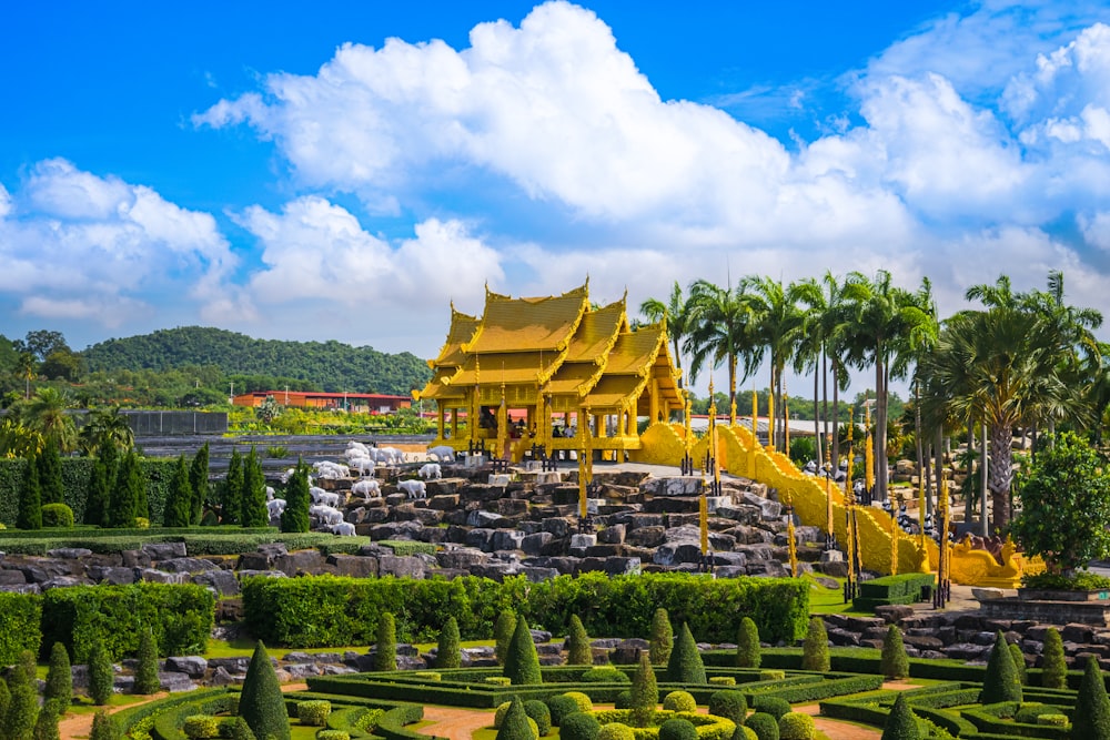 a view of a garden with a yellow building in the background