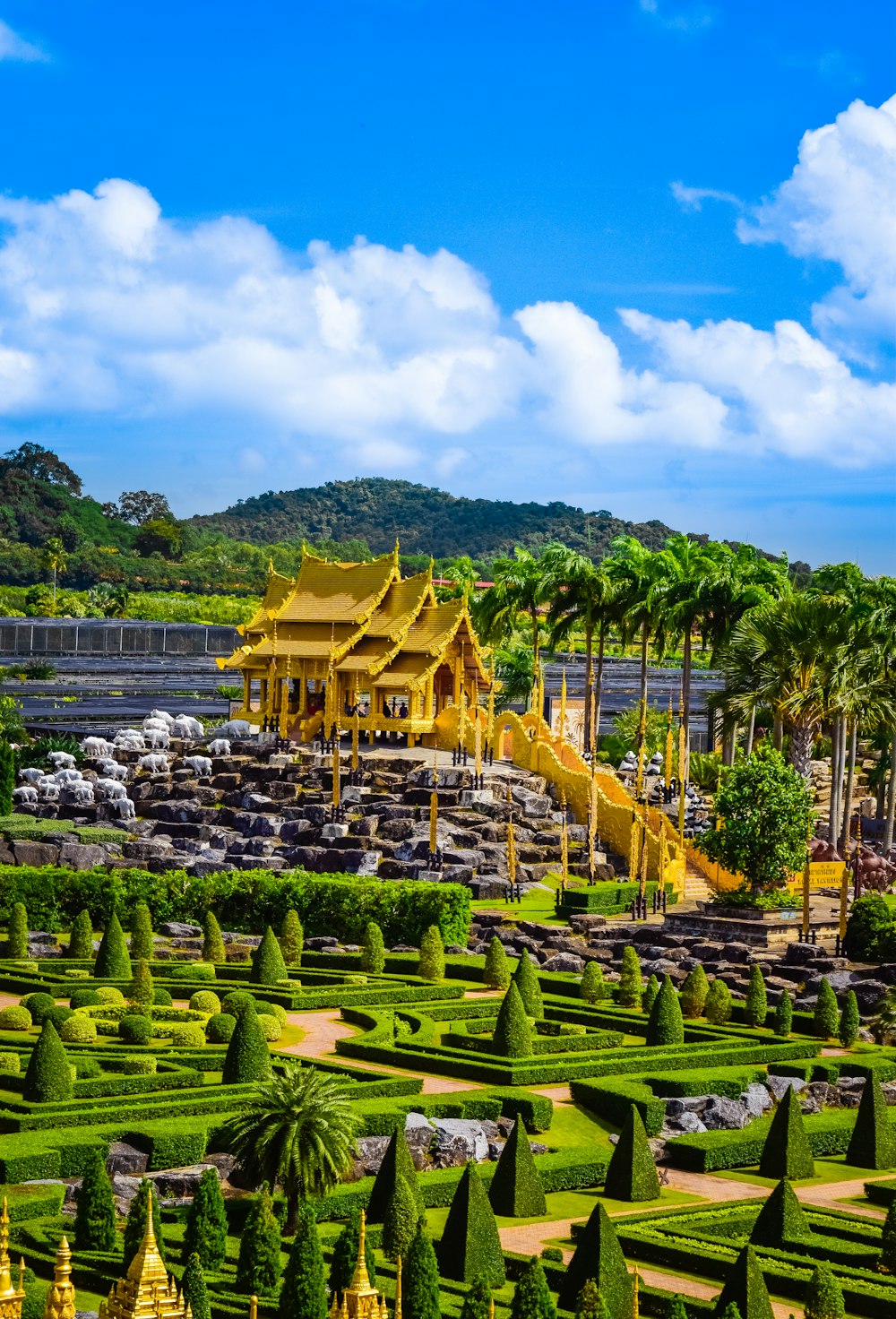 a large garden with a yellow building in the middle of it