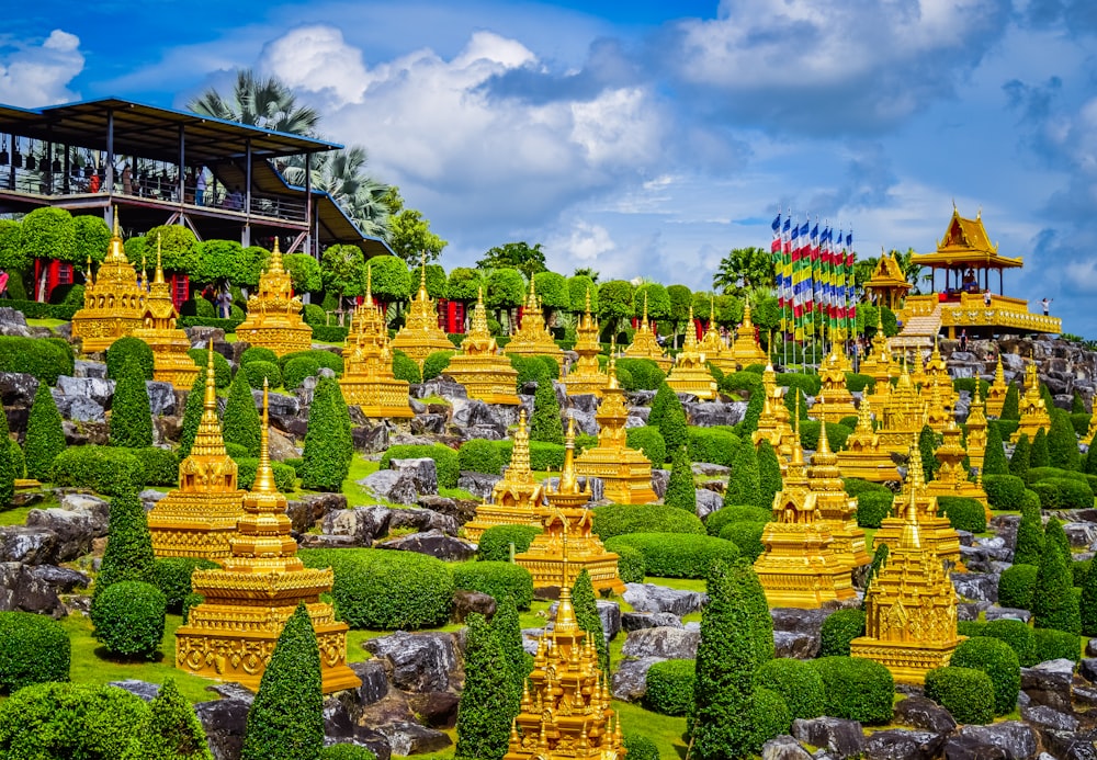 a large group of yellow statues in a garden