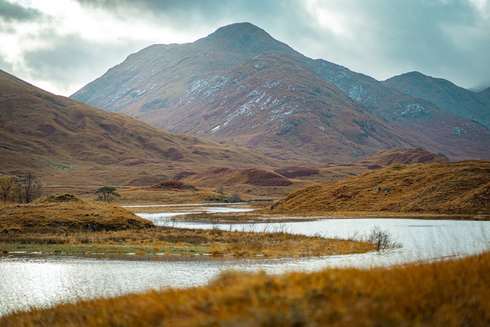 a mountain range with a body of water in the foreground