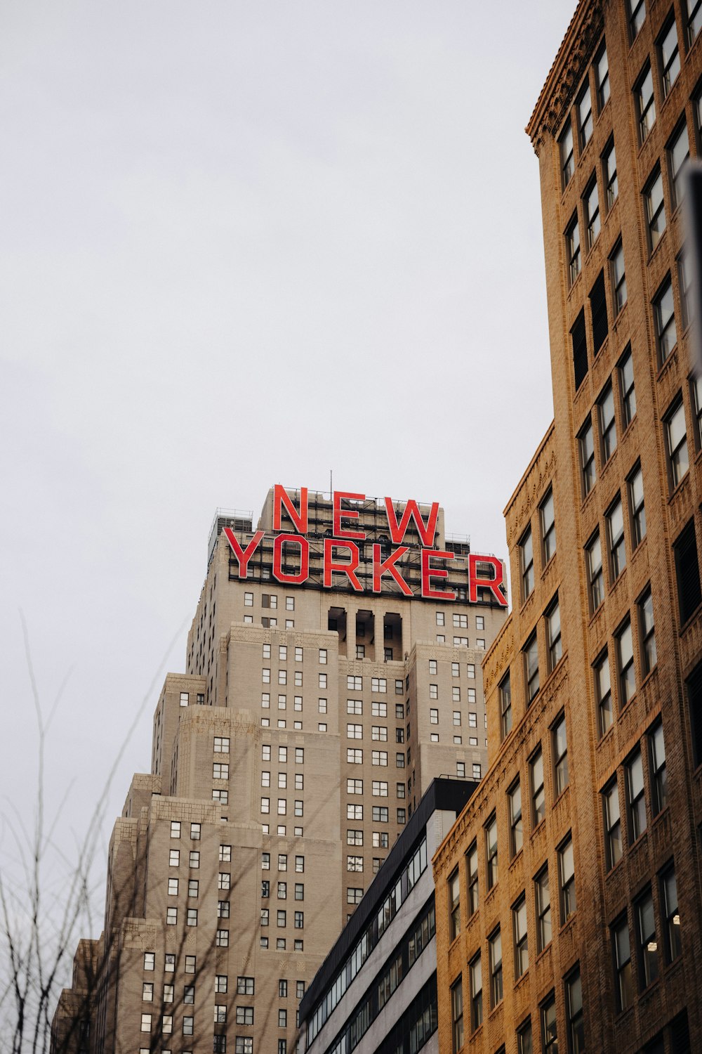 a very tall building with a neon sign on top of it