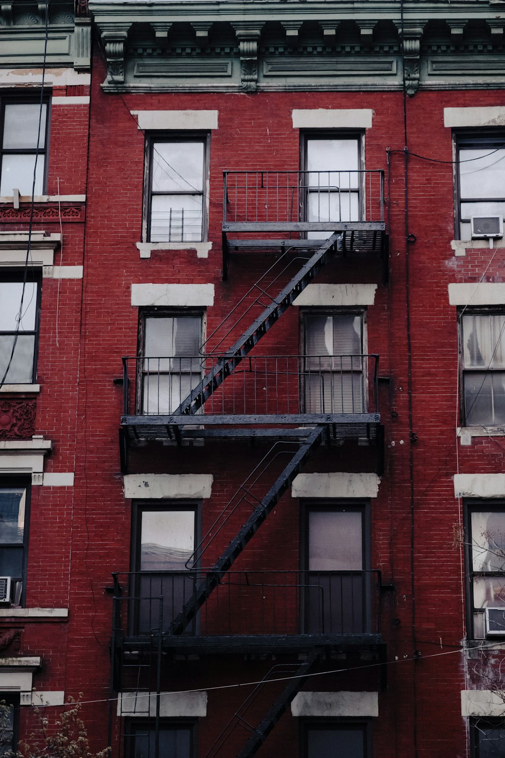 a fire escape on the side of a red brick building