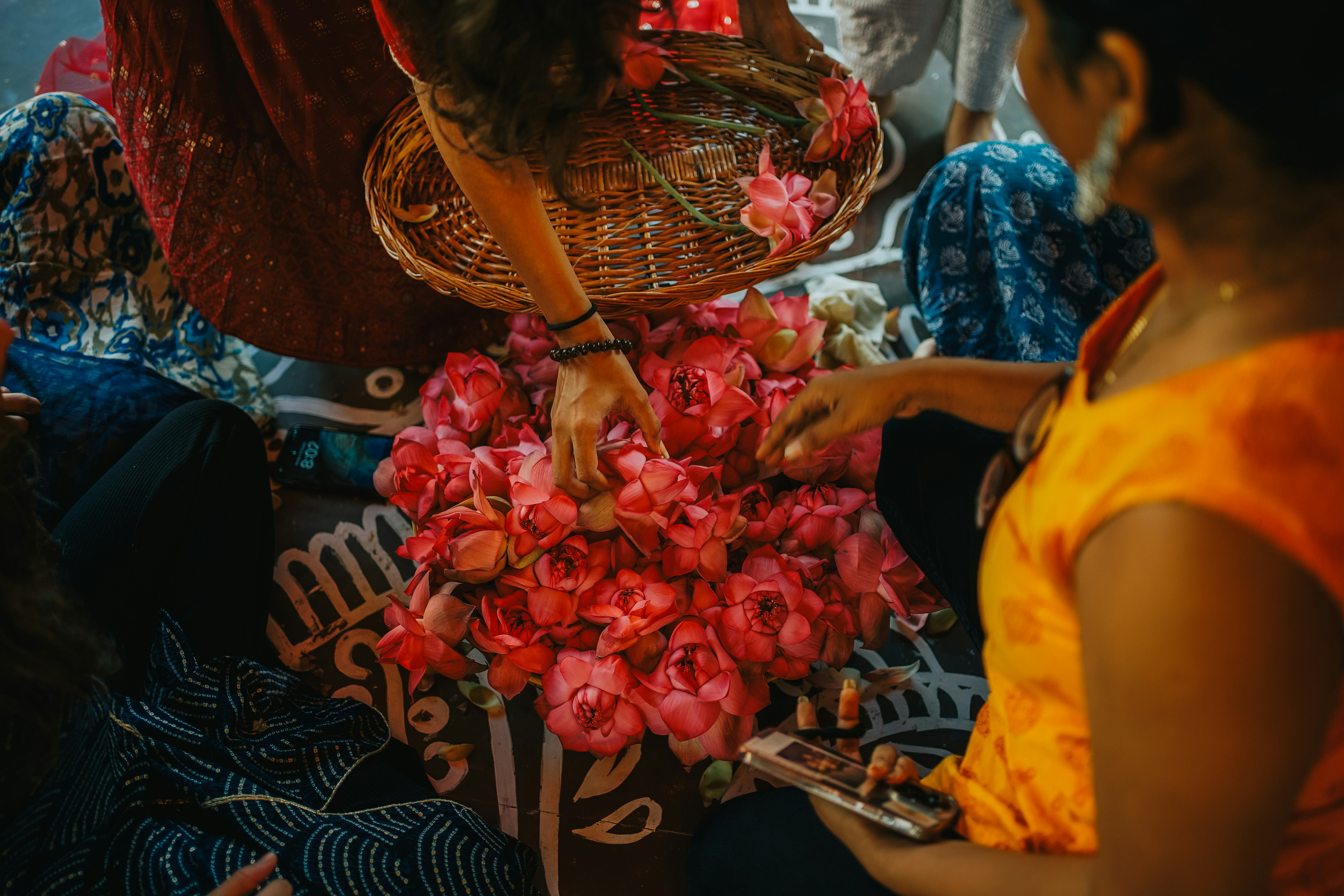 a woman is arranging flowers in a basket