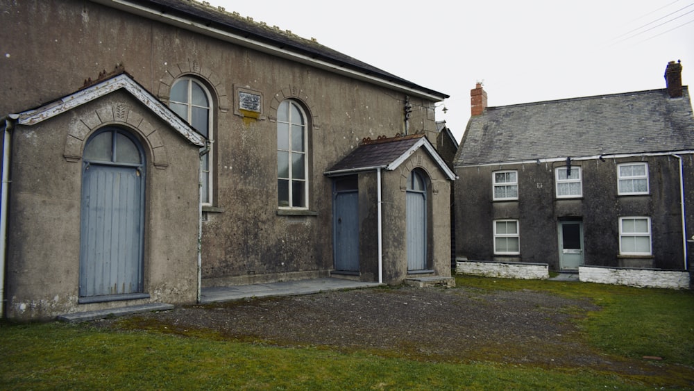 an old building with a blue door and windows