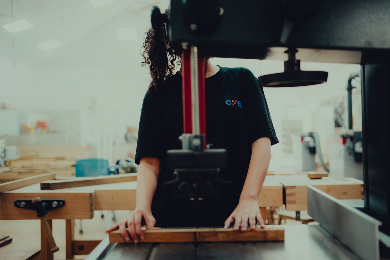 A woman operating a machine on a factory floor