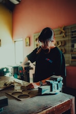 a woman working on a piece of wood