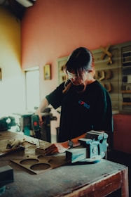 a woman working on a piece of wood