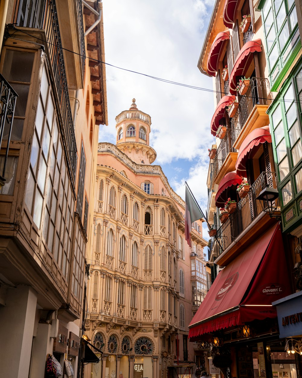 a narrow city street with a building in the background