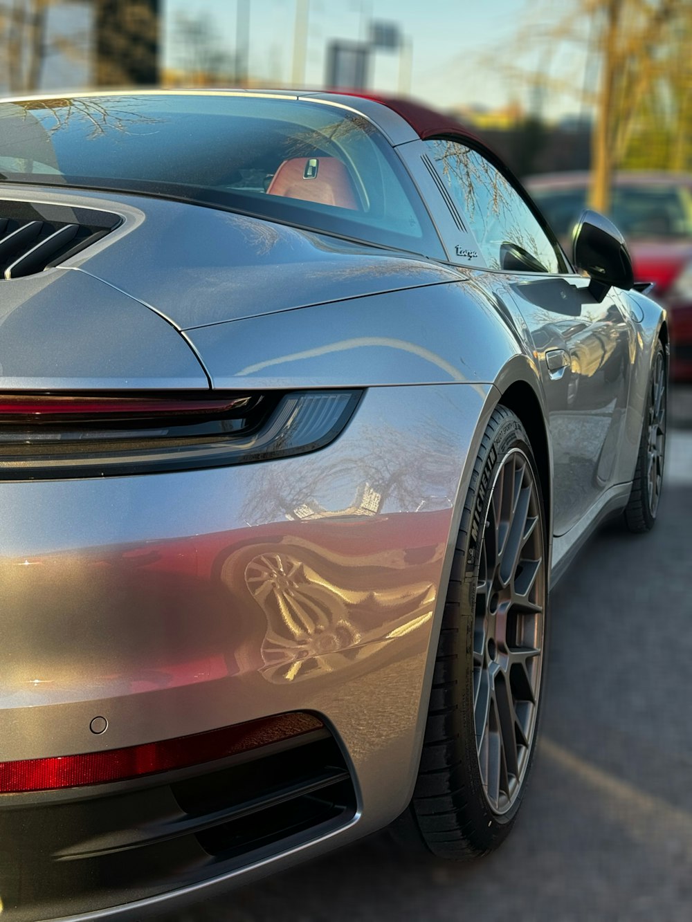 a silver sports car parked on the side of the road