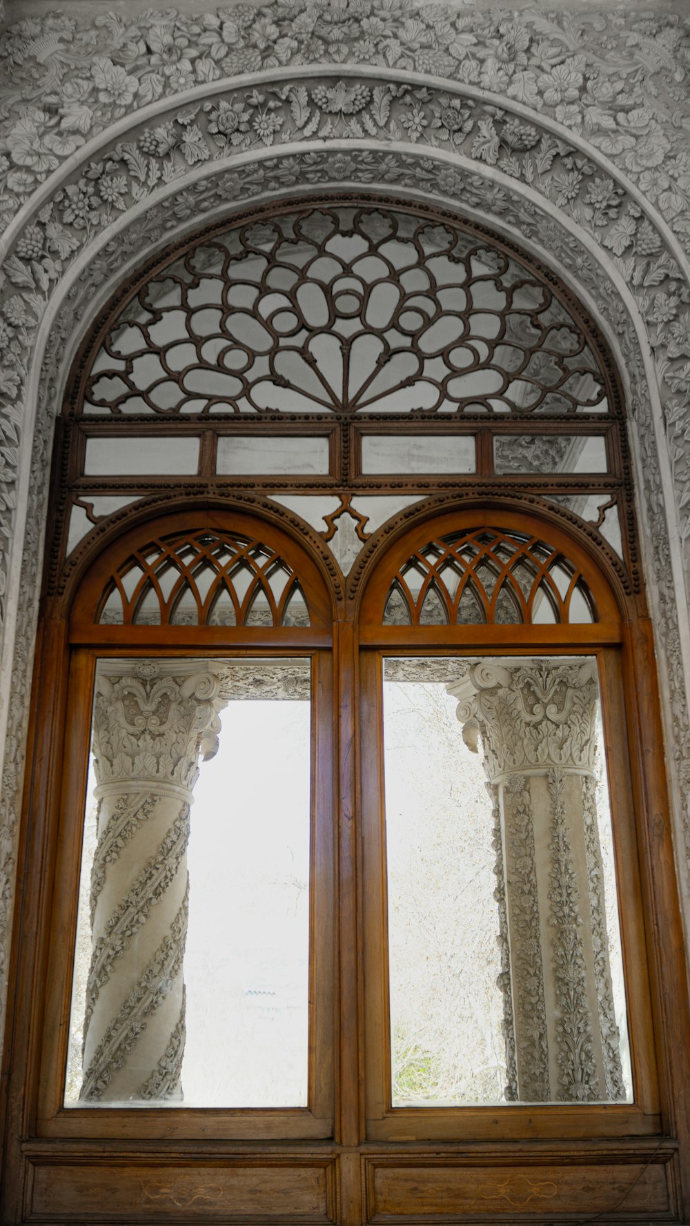 a window with a wooden frame and a curtain