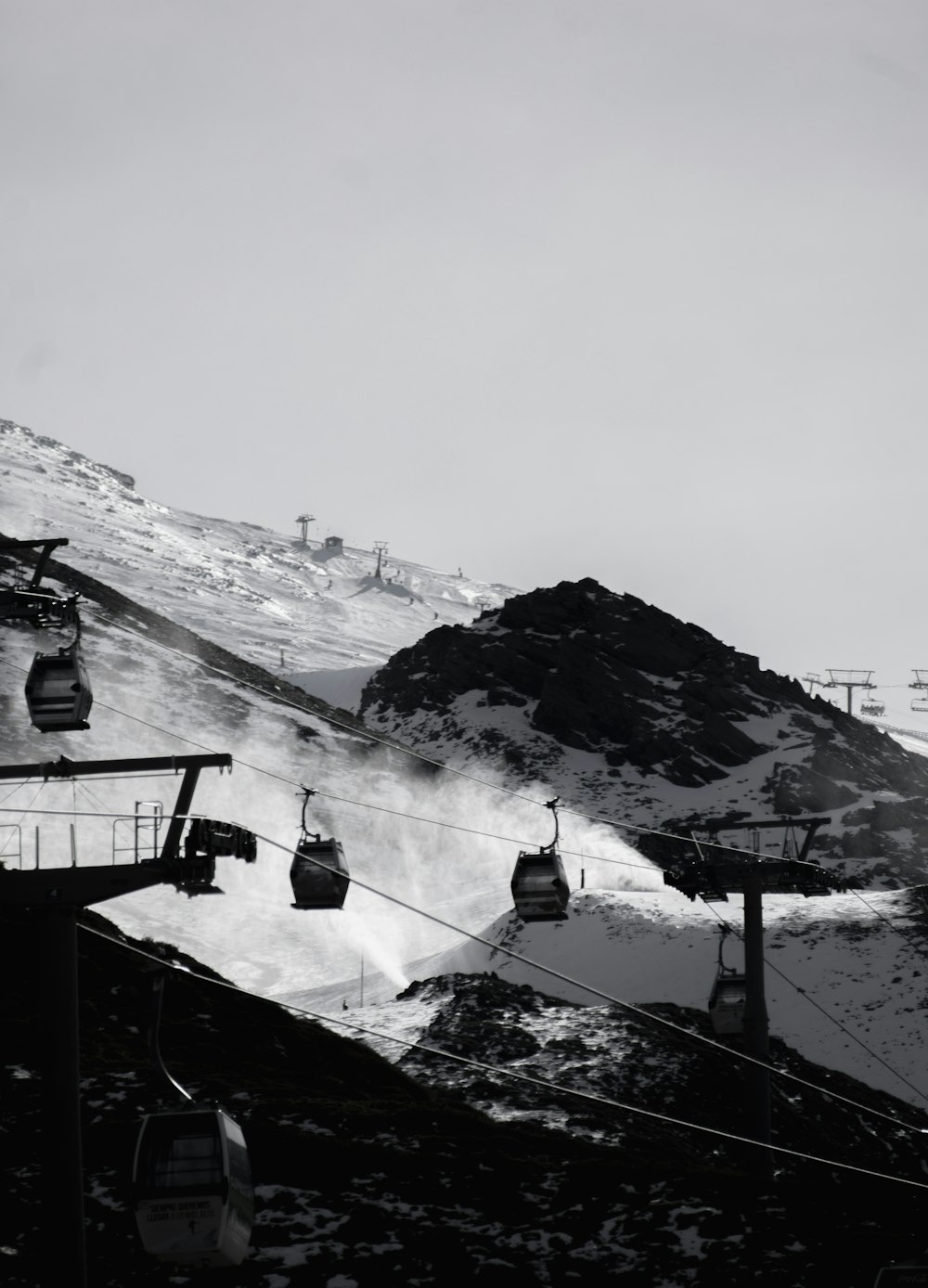 a black and white photo of a ski lift