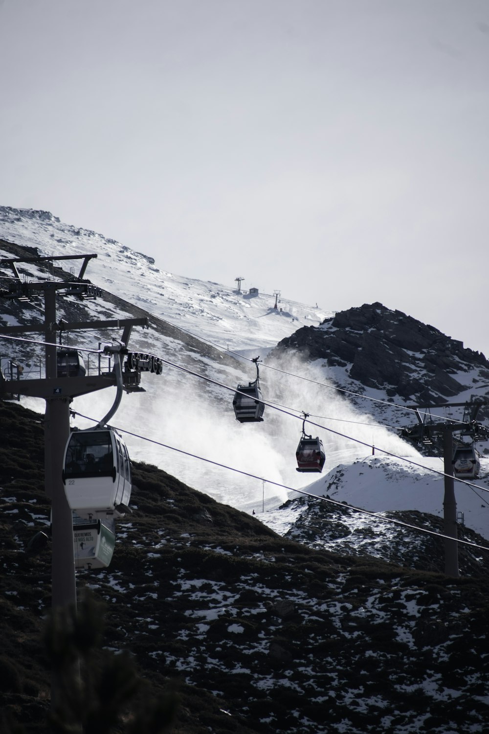 a ski lift going up a snowy mountain