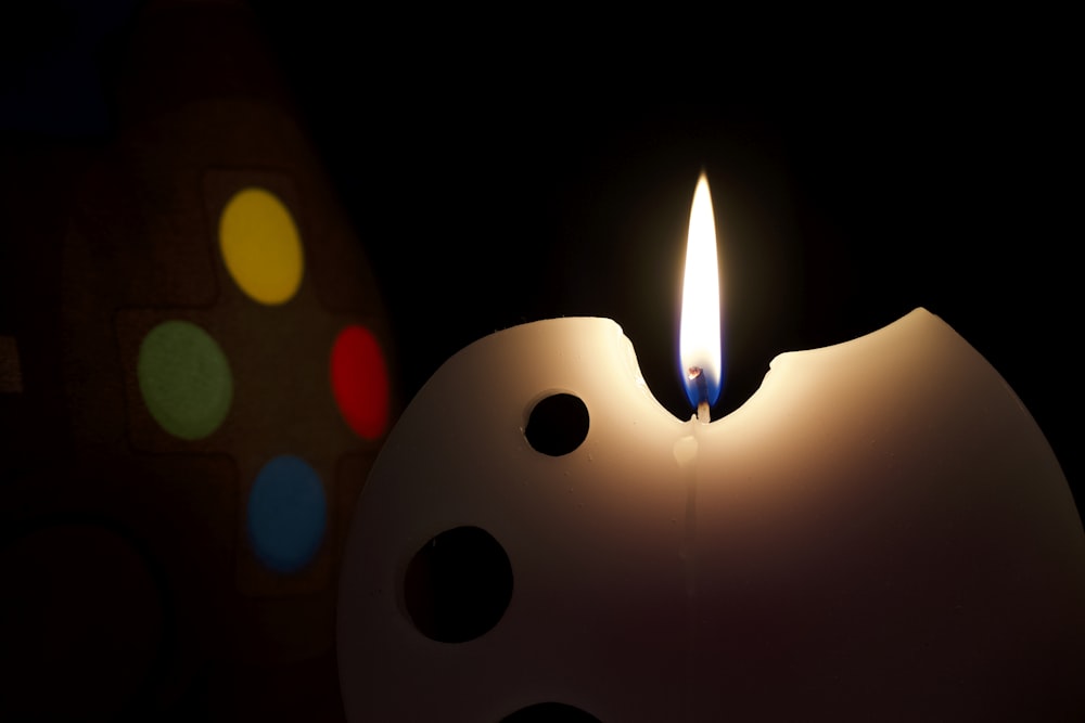 a candle is lit in the shape of a bowling ball