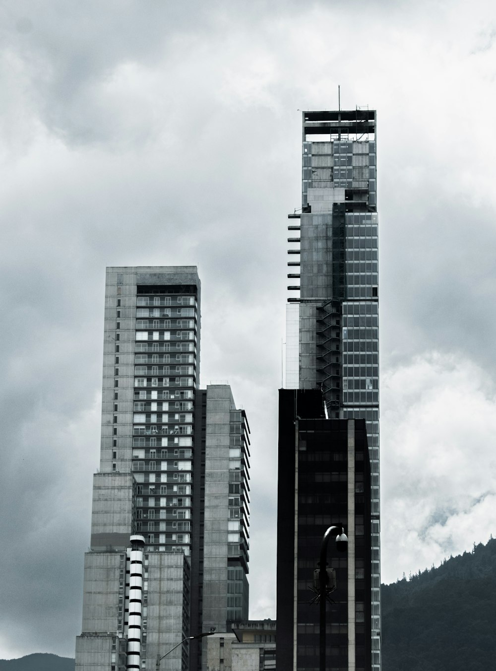 a black and white photo of a city with tall buildings