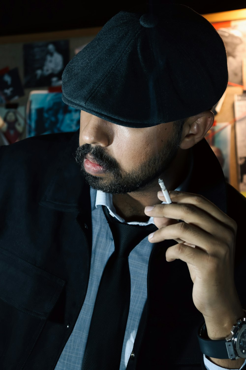 a man smoking a cigarette in a dark room