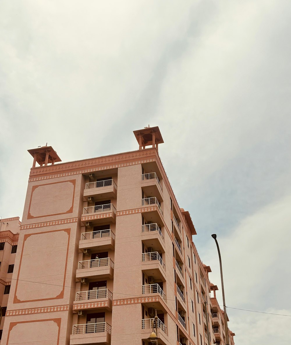 a tall building with balconies on the top of it