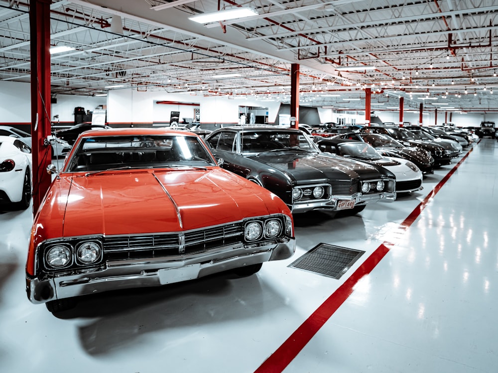 a group of cars parked inside of a garage