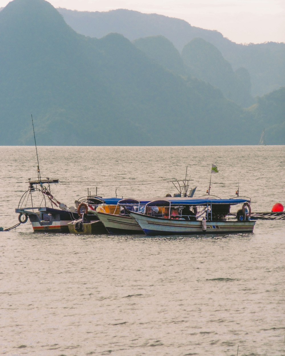 a group of boats floating on top of a large body of water