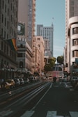 a city street filled with traffic and tall buildings