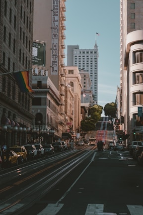 a city street filled with traffic and tall buildings