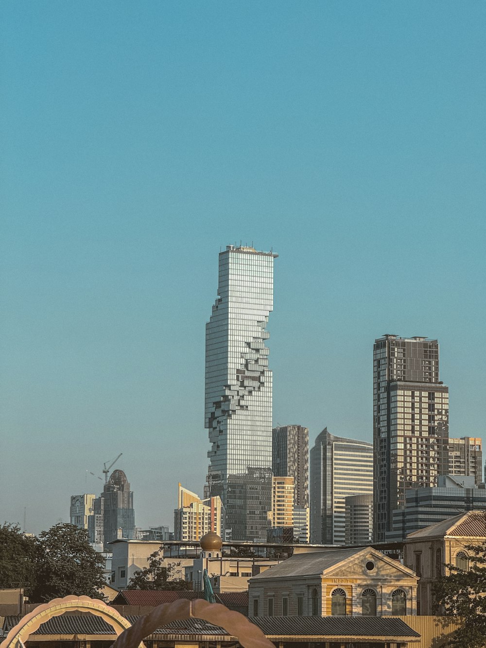 a view of a city skyline with a plane in the foreground