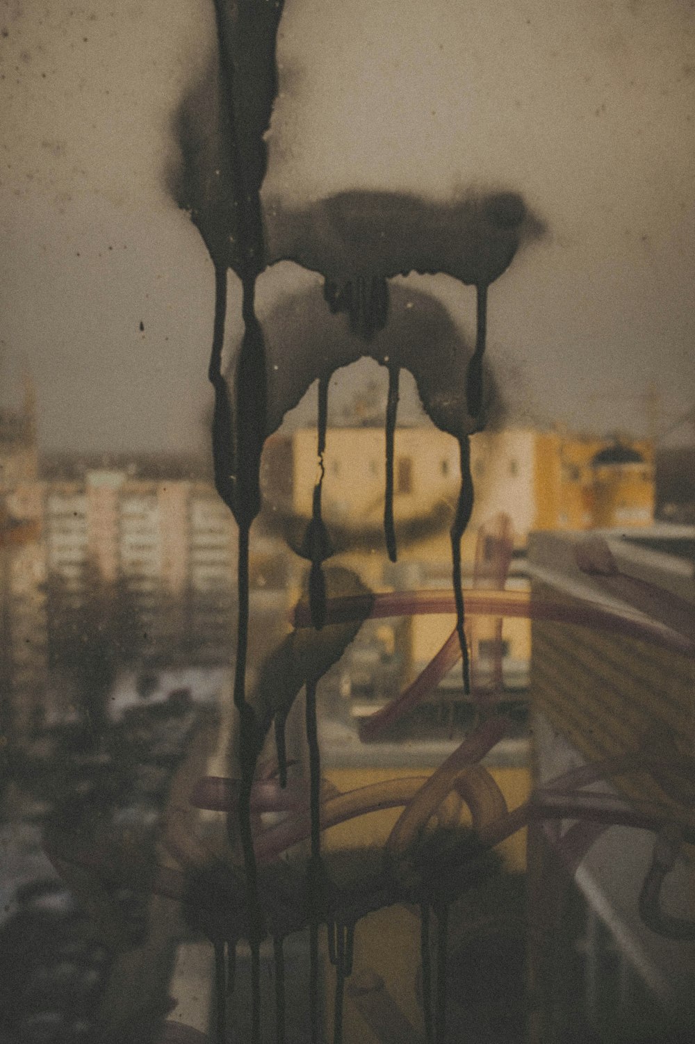 a view of a city from a window covered in icing