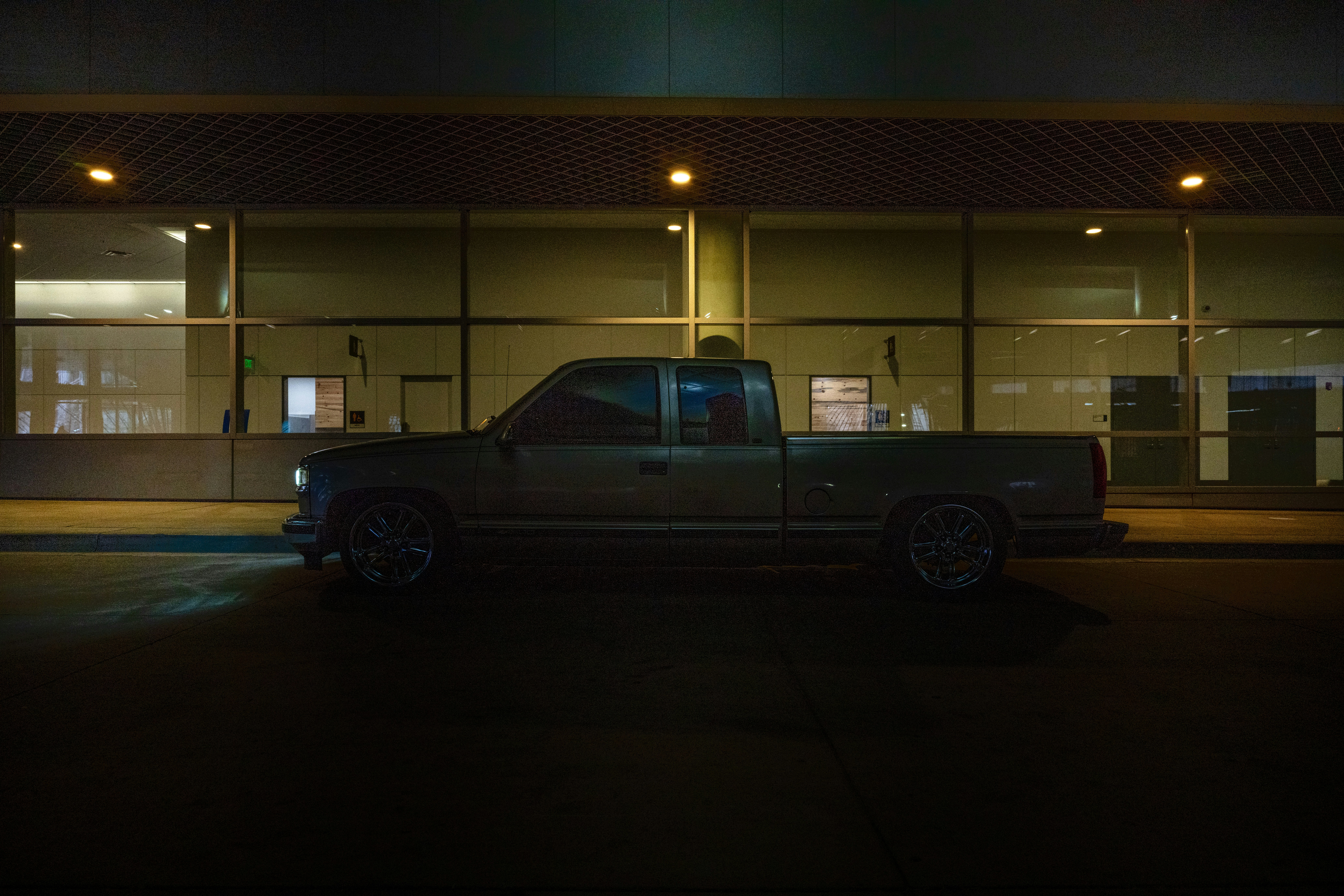 a truck parked in front of a building at night