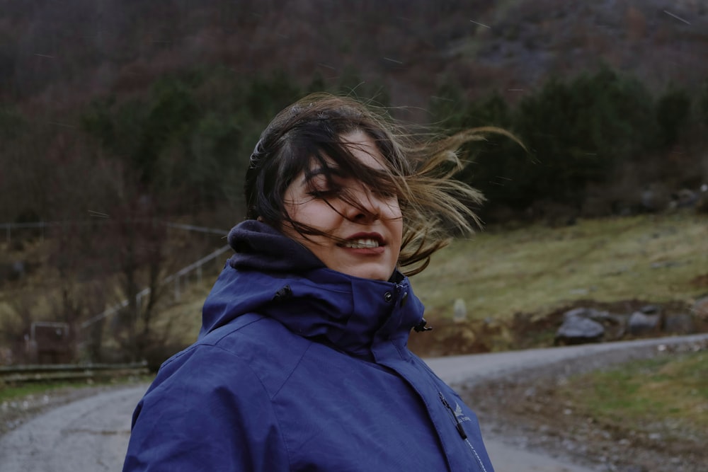 a woman with her hair blowing in the wind