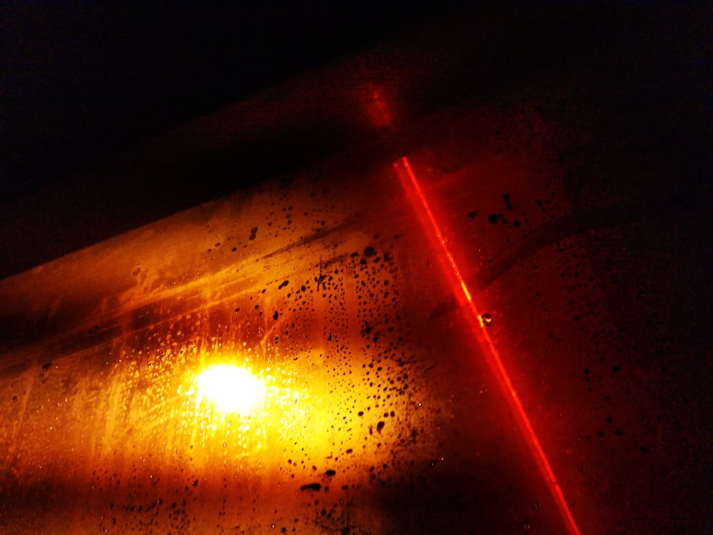 a close up of a street light with rain drops on it