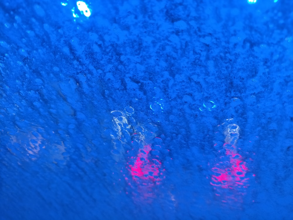 a close up of a street light in the rain