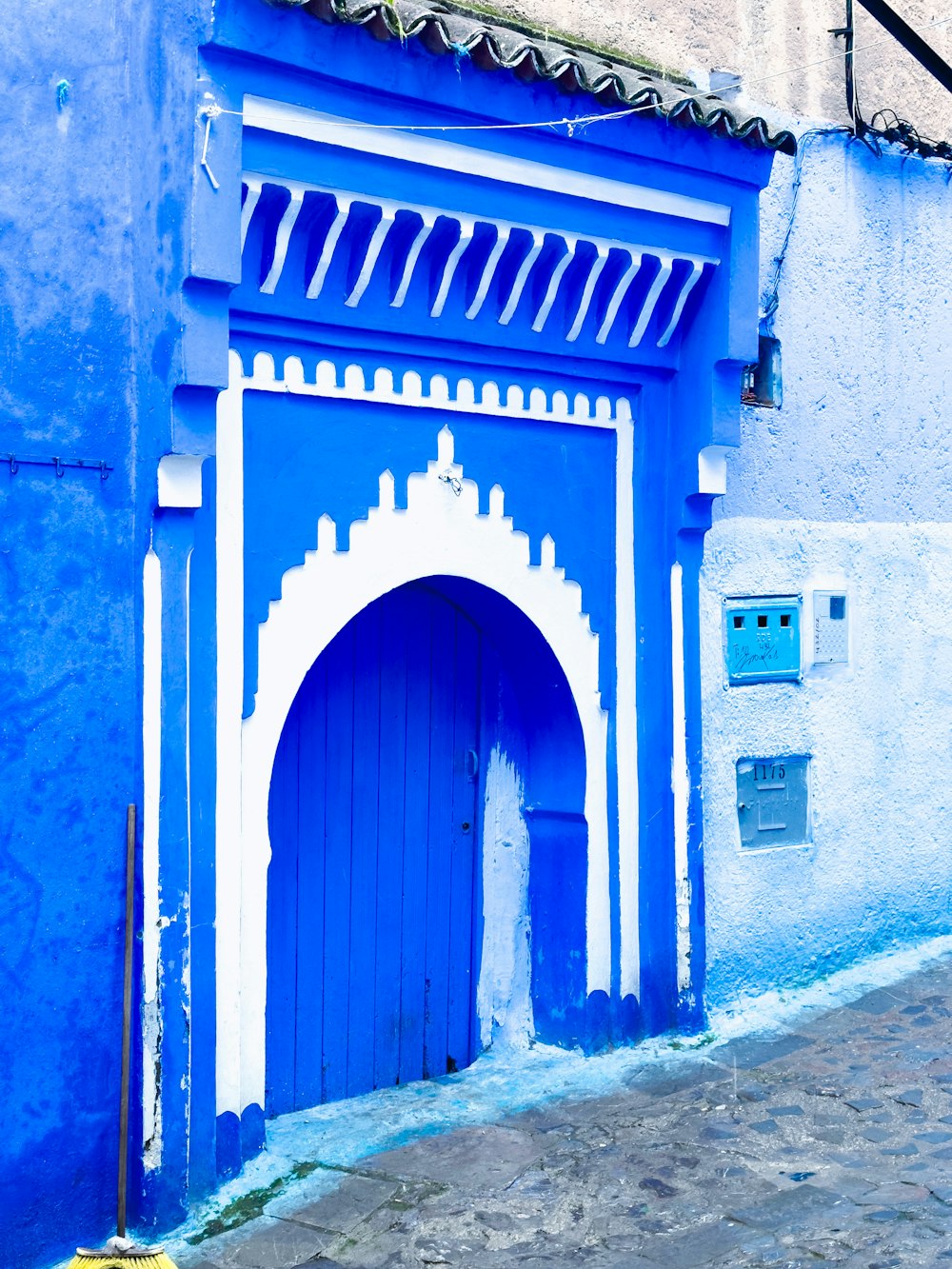 a blue and white building with a blue door