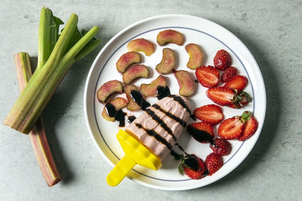 a white plate topped with fruit and vegetables